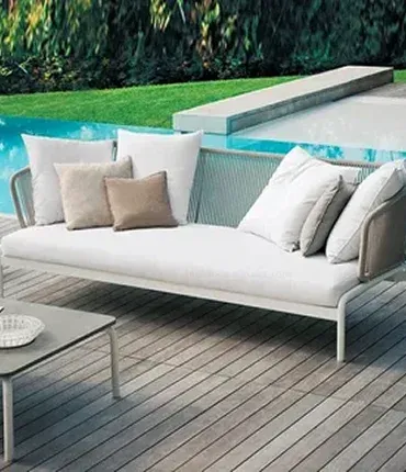 A modern outdoor sofa with white cushions and gray accents