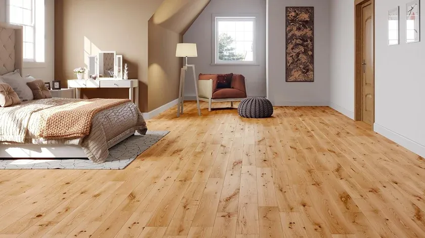 Bright bedroom featuring a cozy bed, wooden floors