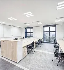 Bright, modern office space with light-colored desks