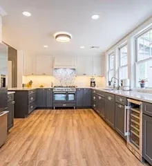 Modern kitchen with gray cabinets, white countertops