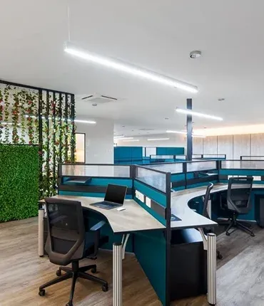 Modern office interior featuring desks with partitions