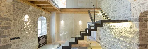 Modern staircase with sleek black steps and glass railing