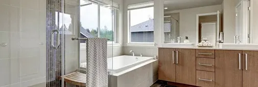 Spacious modern bathroom featuring a glass shower